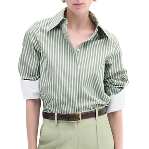 A person wearing CO's Fitted Classic Shirt in green and white vertical stripes with a point collar and rolled sleeves, paired with light green pants and a brown belt.