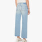 A person wearing The Dodger Flood slouchy, light blue denim jeans by Mother, styled with white heels and standing with their back to the camera against a plain white background.