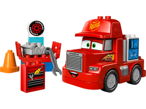 The LEGO® DUPLO® Mack at the Race by Legos - Toyhouse is a red truck with cartoon eyes, “95” and “Rust-eze” decals, plus accessories like a toolbox, cone, engine, tire, and wrench—just like in the Disney Pixar Cars movie.