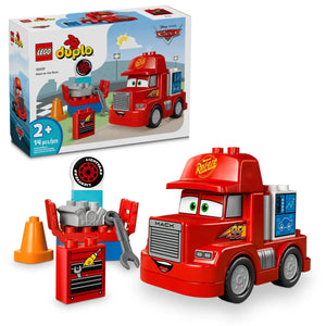 Inspired by LEGO® DUPLO® Mack at the Race from Legos - Toyhouse, this set for ages 2+ includes a red toy truck, toolbox with tools, tire, cones, and an illustrated box showing the assembled Mack truck.