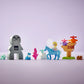 The LEGO® DUPLO® Elsa & Bruni in the Enchanted Forest set by Legos - Toyhouse features Elsa, Bruni, a girl on a blue horse, a gray creature, tree, and accessories; all displayed on a light purple background.