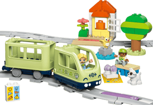 The LEGO® DUPLO® Interactive Adventure Train by Legos - Toyhouse includes two figures, a dog, a small house, trees, and colorful accessories on a curved gray track—an ideal train set for toddlers.