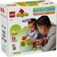 An adult and child play with LEGO® DUPLO® Shape Sorter: Puppy House by Legos - Toyhouse, a set designed for ages 2+, shown on the packaging—perfect for building fine motor skills in little builders.