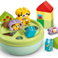The LEGO® DUPLO® Shape Sorter: Puppy House by Legos - Toyhouse features colorful blocks, animal and fruit pieces arranged in and around a green round sorter, making it a fun fine motor skills toy.