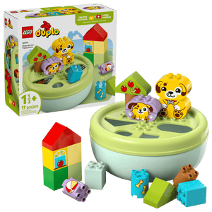 The LEGO® DUPLO® Shape Sorter: Puppy House by Legos - Toyhouse is for ages 1+, featuring animal and food graphic blocks, a round green container, and an illustrated box—ideal as a shape sorter and fine motor skills toy.