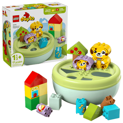 The LEGO® DUPLO® Shape Sorter: Puppy House by Legos - Toyhouse is for ages 1+, featuring animal and food graphic blocks, a round green container, and an illustrated box—ideal as a shape sorter and fine motor skills toy.