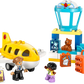 The LEGO® DUPLO® First Time at the Airport by Legos - Toyhouse includes a yellow airplane, control tower, two minifigures, suitcases, and a teddy bear—ideal for preschoolers who love aviation and building fun.