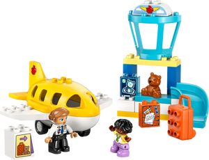 The LEGO® DUPLO® First Time at the Airport by Legos - Toyhouse includes a yellow airplane, control tower, two minifigures, suitcases, and a teddy bear—ideal for preschoolers who love aviation and building fun.