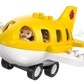 The LEGO® DUPLO® First Time at the Airport by Legos - Toyhouse is a yellow and white toy airplane with wheels, featuring two smiling figures visible through its windows.
