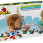 Two children play with the LEGO® DUPLO® F1® Team Race Cars & Drivers by Legos - Toyhouse, surrounded by colorful blocks—an exciting Formula 1 building set that’s also a great learning toy for toddlers.