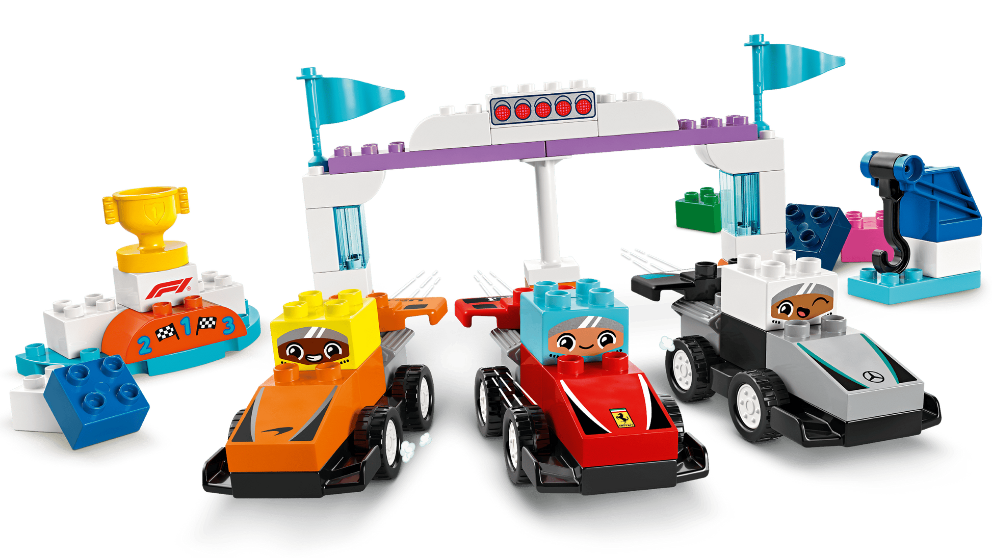 Three LEGO® DUPLO® F1® Team Race Cars & Drivers by Legos - Toyhouse, featuring colorful cars, drivers with cartoon faces, blocks, a trophy, and race accessories—perfect as an F1 race car and learning toy for toddlers.