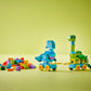 The LEGO® DUPLO® 3in1 Dinosaurs on Wheels by Legos - Toyhouse features two colorful dinosaur toys with wheels and loose bricks on the left, all set against a light green background.