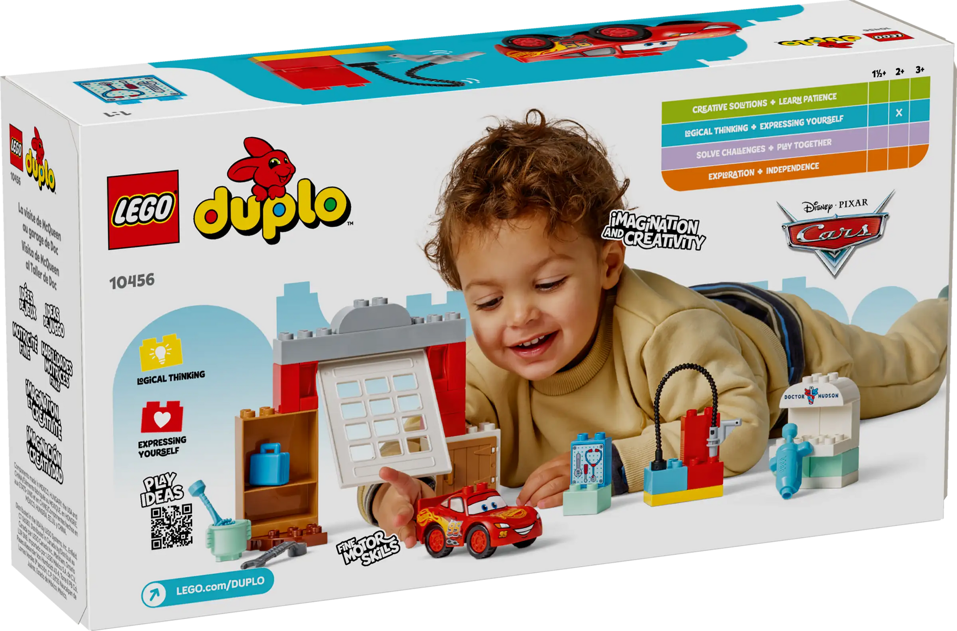 A young child plays with the LEGO® DUPLO® McQueen's Visit to Doc's Garage set from Legos - Toyhouse, which features a buildable race car, garage pieces, and themed accessories.