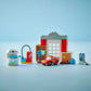 The LEGO® DUPLO® McQueen's Visit to Doc's Garage by Legos - Toyhouse features a buildable race car toy displayed with garage accessories and buildings on a light blue background.