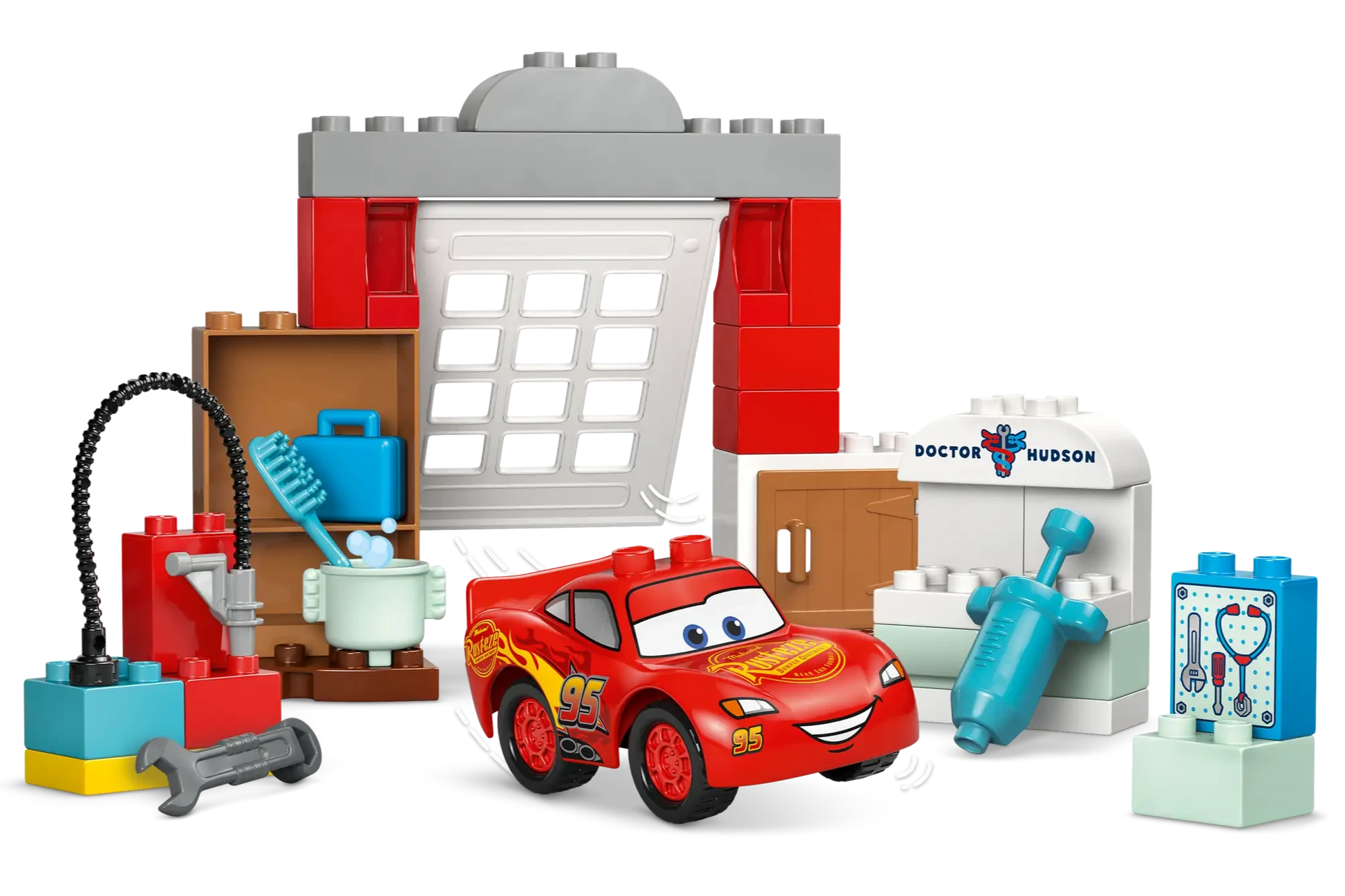 The Legos - Toyhouse LEGO® DUPLO® McQueen's Visit to Doc's Garage playset includes a buildable Lightning McQueen race car, garage backdrop, workbench, medical tools, and fun repair and medical station accessories for toddlers.
