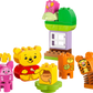 The LEGO® DUPLO® Disney™ Winnie the Pooh's Birthday Party by Legos - Toyhouse features Piglet, Tigger, numbered blocks, a green and purple house, and a “hunny” pot block—perfect for imaginative and educational play.