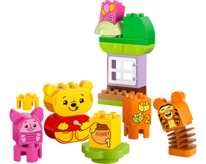 The LEGO® DUPLO® Disney™ Winnie the Pooh's Birthday Party by Legos - Toyhouse features Piglet, Tigger, numbered blocks, a green and purple house, and a “hunny” pot block—perfect for imaginative and educational play.