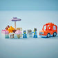 The LEGO® Ice Cream Trip with Bluey by Legos - Toyhouse includes an ice cream stand, desserts, two animal figures, a cash register, and an orange toy car—an ideal colorful toddler toy on a light blue background.