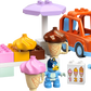 The LEGO® Ice Cream Trip with Bluey set by Legos - Toyhouse features two Bluey figures, an orange car, colorful ice cream cones, a register, and numbered menu board—ideal for play or adding to your LEGO DUPLO Bluey collection.