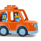 The LEGO® Ice Cream Trip with Bluey by Legos - Toyhouse features two cartoon dog figurines in a red car beside a white block with treats, making it perfect for any toddler toy collection.