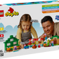 A child and an adult enjoy LEGO® DUPLO® Grandpa Pig's Garden and Greenhouse by Legos - Toyhouse, a preschool learning toy with interactive pieces, developmental benefits, and playful fun for toddlers.