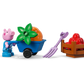 The LEGO® DUPLO® Grandpa Pig's Garden and Greenhouse by Legos - Toyhouse features three pig figurines with gardening tools, a plant, a shovel, and a crate of red vegetables—perfect for charming toddler play.