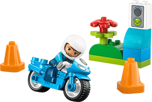 The LEGO® DUPLO® Blue Police Motorcycle by Legos - Toyhouse includes an officer, two orange cones, a flower on green blocks, and a traffic light for fun emergency play and toddler learning.
