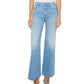 A model showcases Mother’s The Hustler Roller Sneak high-waisted, light blue stretch denim flare jeans with a white top, standing against a plain background; only the lower torso and legs are visible.