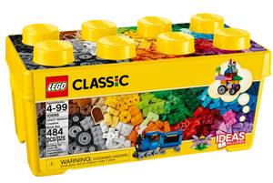 The LEGO® Classic Medium Creative Brick Box by Legos - Toyhouse is a yellow storage box with 484 colorful bricks for ages 4-99, featuring a small blue train build for creative fun on its packaging.