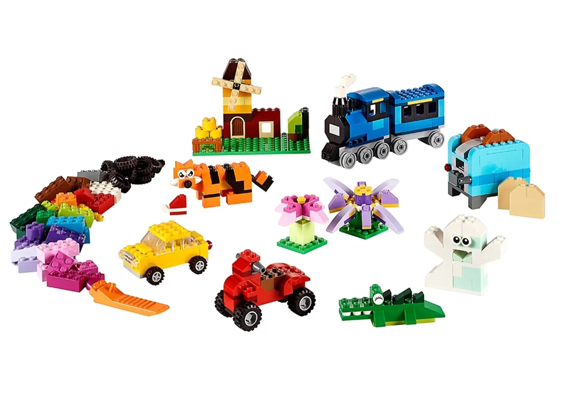 A variety of colorful creations built with LEGO® Classic Medium Creative Brick Box by Legos - Toyhouse, including vehicles, animals, a house, a train, flowers, and fantasy figures, are displayed on a white background.