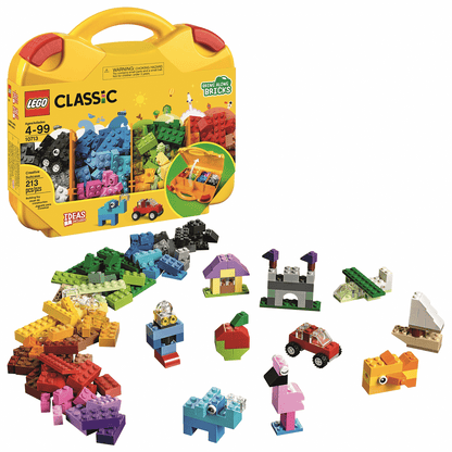 The LEGO® Classic Creative Suitcase by LEGO® opens to reveal assorted colorful bricks and small built models—like a car, animals, and shapes—displayed in front to inspire creative play.