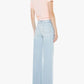 Facing away from the camera against a plain white background, the person is wearing The Hustler Roller Skimp Fray jeans by Mother in a light blue wash, paired with a light pink short-sleeve top and black sandals.