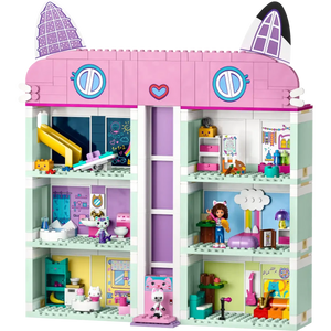 A vibrant, multi-level toy house with cat-like roof ears mimics LEGO® Gabby's Dollhouse. Each room includes a sliding elevator, detailed with furniture and figures, exuding playful and cozy vibes. From Legos - Toyhouse brand.