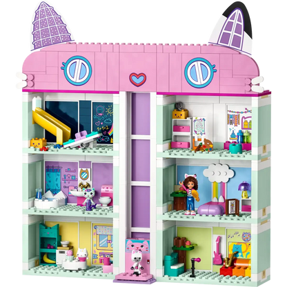 A vibrant, multi-level toy house with cat-like roof ears mimics LEGO® Gabby's Dollhouse. Each room includes a sliding elevator, detailed with furniture and figures, exuding playful and cozy vibes. From Legos - Toyhouse brand.