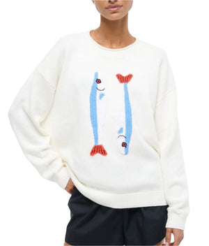 Person wearing the Staud Giada Sweater, a lightweight summer knit with a sardines jacquard front, paired with black shorts.