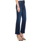 Wearing the Mother Tripper Flood dark blue high-rise flare bootcut jeans, styled with a white top, gold bracelet, and pointed glittery heels, this person stands against a white background.