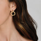 Anabel Aram Bamboo Double Hoop Earrings: small gold-plated brass hoops with a textured, segmented bamboo design worn in an earlobe.