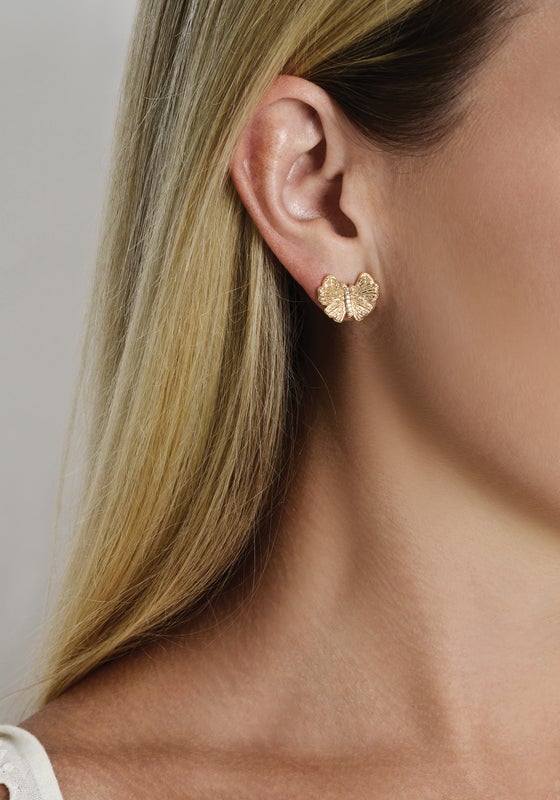 Anabel Aram Butterfly Stud Earrings crafted from gold, worn on an earlobe.