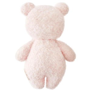 The Baby Boucle Bear - Strawberry by Cuddle + Kind is a fluffy, light pink teddy bear plush, hand-knit from heirloom-quality Peruvian cotton yarn, shown from the back with round ears and limbs against a plain white background.