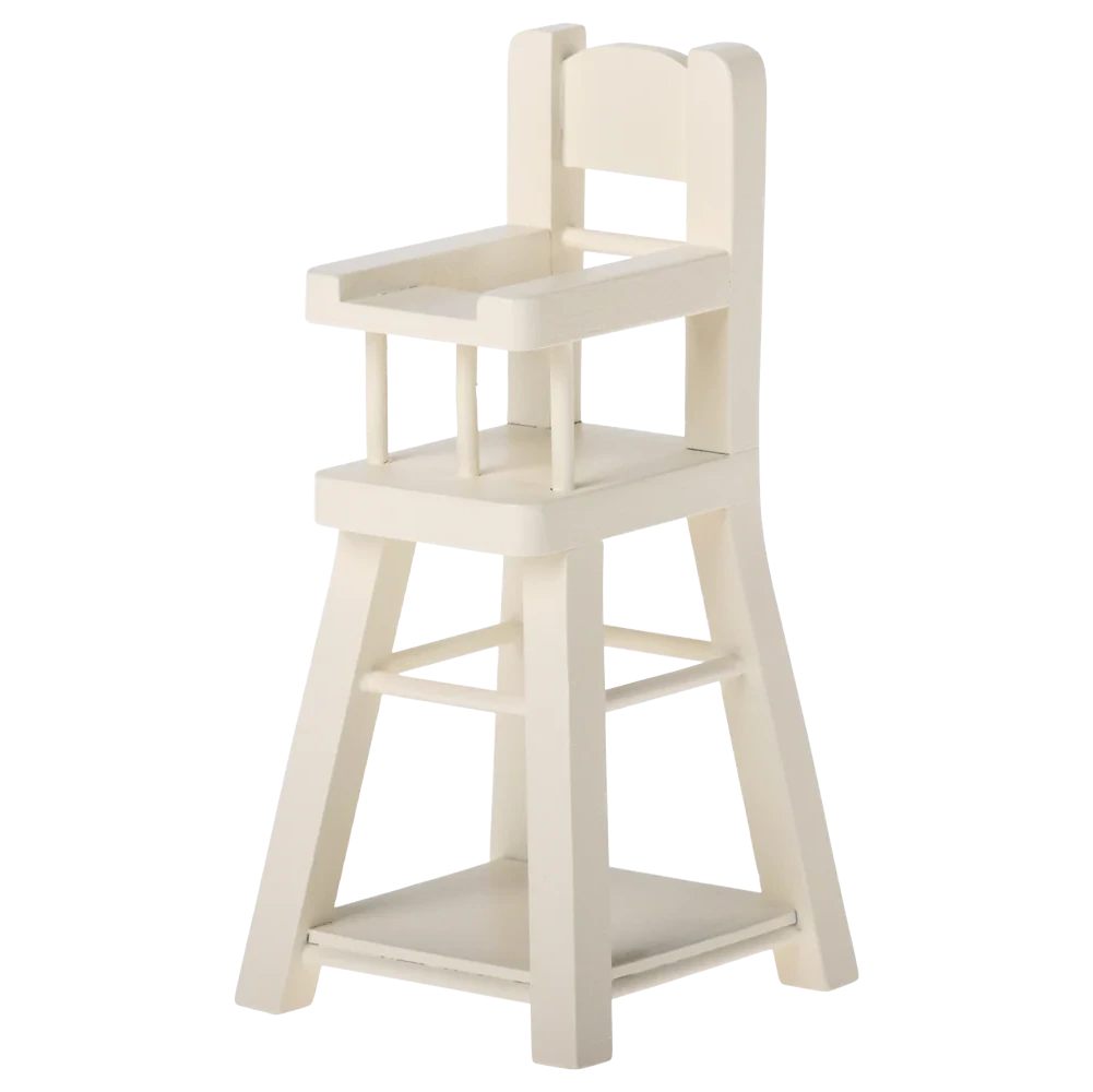 The Maileg High Chair - Micro is a small, white wooden chair with a backrest, armrests, and footrest—perfectly sized for micro bunnies or other Micro-sized Maileg friends.