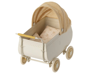 The Maileg Yellow Pram - Micro is a charming, vintage-style cream-colored toy baby carriage featuring a yellow plaid canopy and matching bedding—perfect for adding character to your dollhouse or for carrying micro-sized bunnies on delightful adventures.