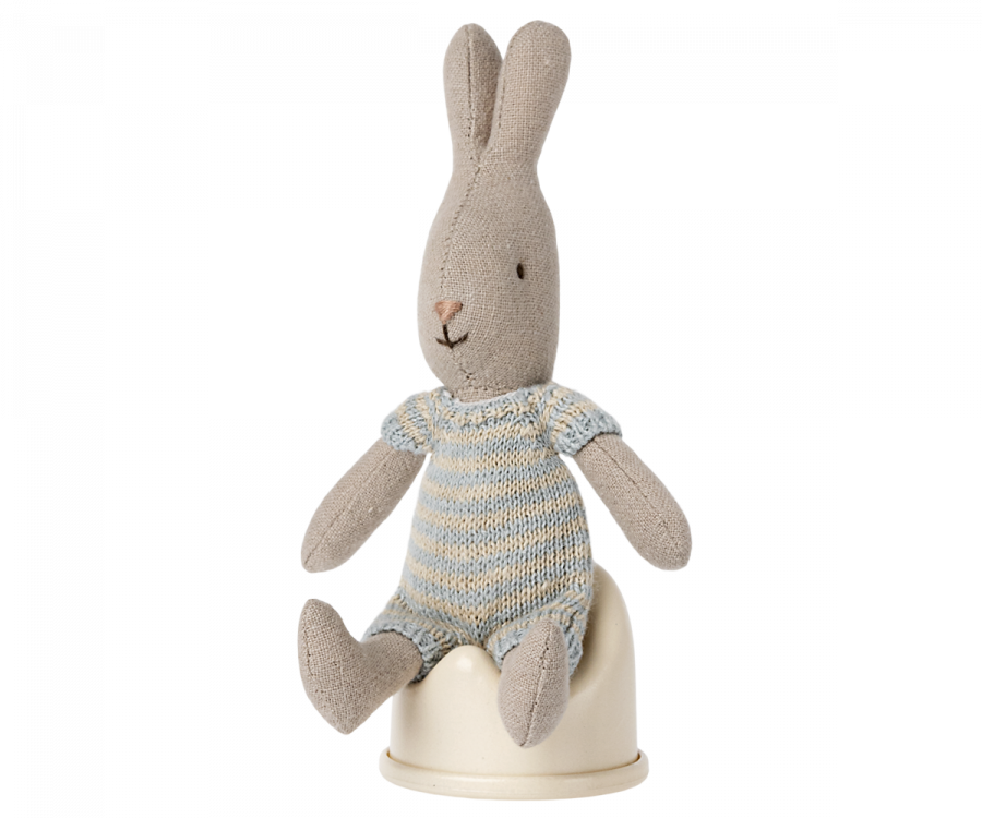 Plush rabbit toy in a blue and white outfit sitting on a Maileg Off-White Potty, Micro on a white surface.