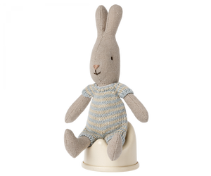 Plush rabbit toy in a blue and white outfit sitting on a Maileg Off-White Potty, Micro on a white surface.