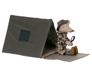 The Maileg Single Tent, Mouse features a cute stuffed mouse in a plaid shirt and hat, holding a magnifying glass and sitting on a mat—perfect for imaginative sleepovers under the stars.