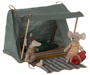 Two plush mice in a Maileg Happy Camper Tent with one sitting inside and the other about to enter.