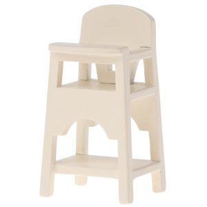 The Maileg High Chair, Mouse - Off White is a charming wooden chair with backrest, armrests, and footrest, perfect for seating a small child or as a whimsical pet accessory.