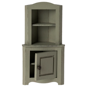 The Maileg Corner Cabinet, Mouse - Light Green, is a small vintage-style piece with two open shelves and a lower cabinet door—perfect for adding unique charm to your home decor.