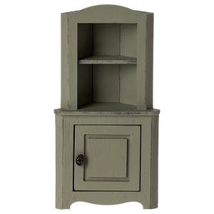 The Maileg Corner Cabinet, Mouse – Light Green, is a small wooden cabinet with a vintage finish, featuring an upper shelf and lower closed door with a round knob—ideal for stylish home decor.