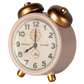 The Maileg Alarm Clock, Mouse - Powder, is a charming vintage-style pink clock featuring gold metal bells and legs, displaying 10:10 with exquisite small details.