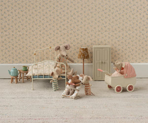 Maileg’s Pram, Mouse - Coral adds to a charming vintage scene with baby mice in a miniature bedroom, complete with bed, lamp, wardrobe, tea set, and pram on a carpeted floor.